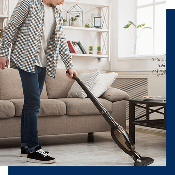 man vacuuming his living room
